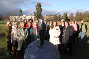 Group stands behind new sculpture by Adrian Reynolds